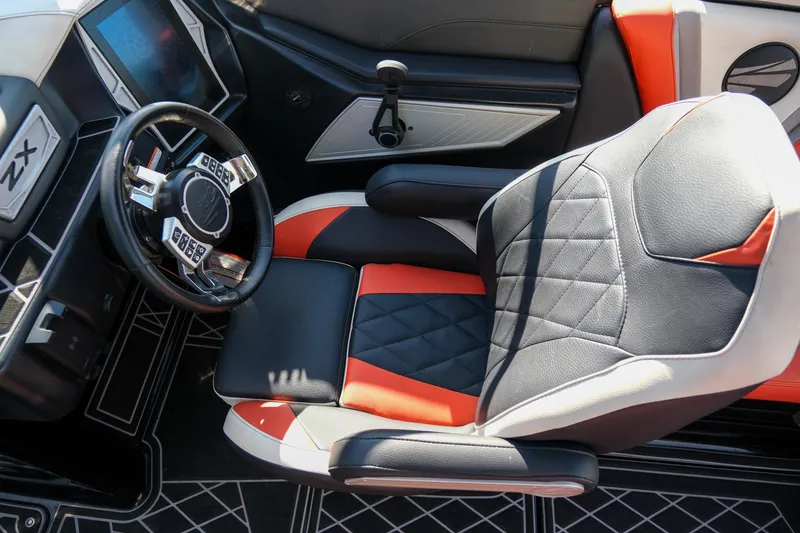 Slide: The Image of 2021 Tigé 21ZX boat interior with modern steering wheel and stylish seating. - 15