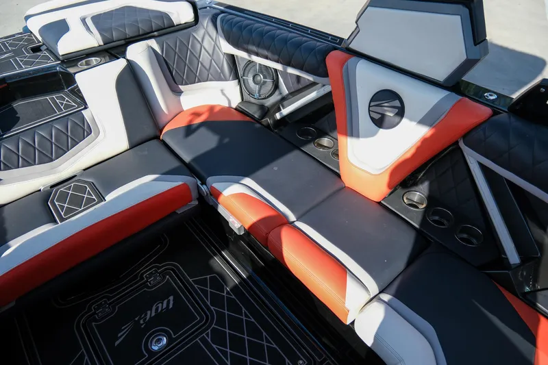 Slide: The Image of 2021 Tigé 21ZX boat interior with stylish black, white, and orange seating. - 18