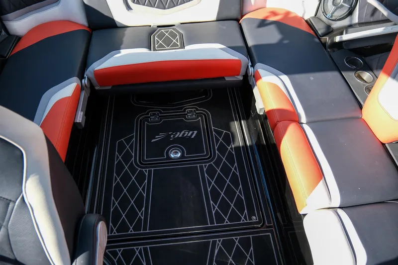 Slide: The Image of 2021 Tigé 21ZX boat interior with stylish black, red, and white seating. - 20
