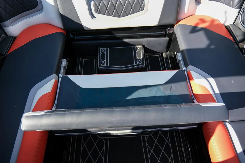 Slide: The Image of 2021 Tigé 21ZX boat interior with black, red, and white seating design. - 21