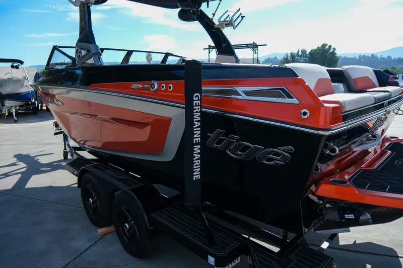 Slide: The Image of 2021 Tigé 21ZX boat in vibrant orange and black, displayed at Germaine Marine. - 28