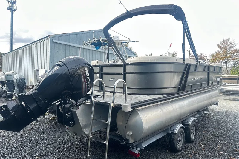 Slide: The Image of 2019 Starcraft 2210 OB Limited pontoon boat with Mercury outboard motor on trailer. - 1
