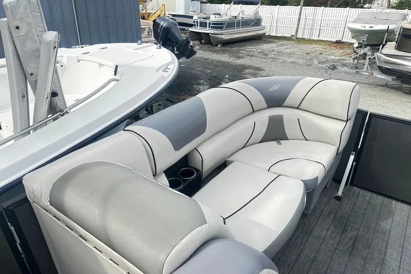 Slide: The Image of 2019 Starcraft 2210 OB Limited boat with gray seating and cup holders. - 10