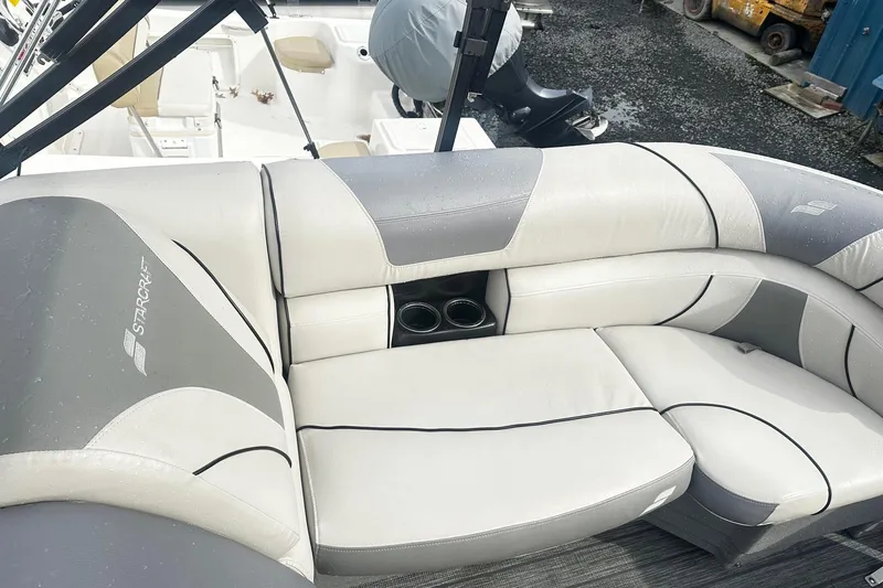 Slide: The Image of 2019 Starcraft 2210 OB Limited boat interior with gray and white cushioned seating. - 11