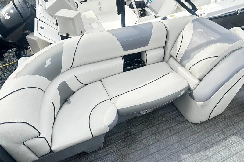 Slide: The Image of 2019 Starcraft 2210 OB Limited boat interior with gray cushioned seating and cup holders. - 13