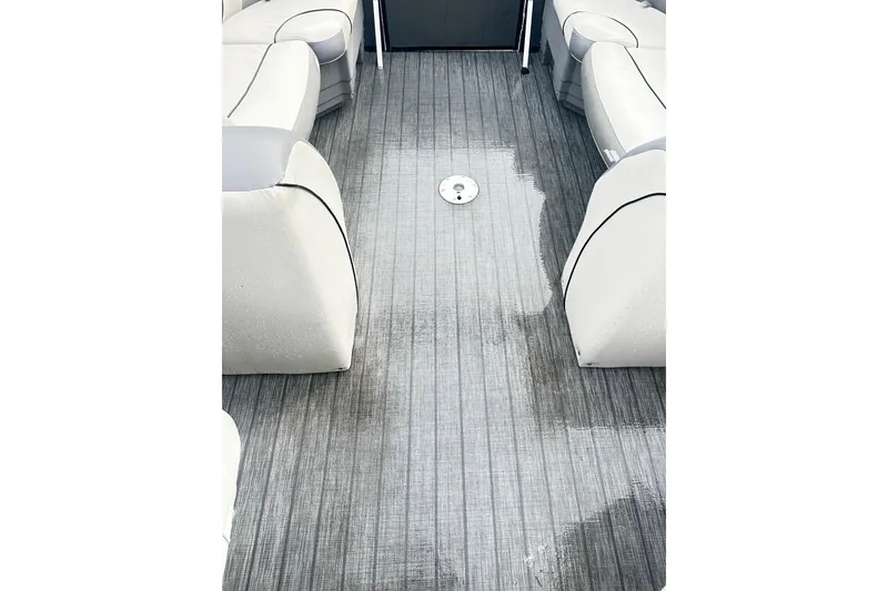 Slide: The Image of 2019 Starcraft 2210 OB Limited boat interior with wet gray flooring and white seating. - 14