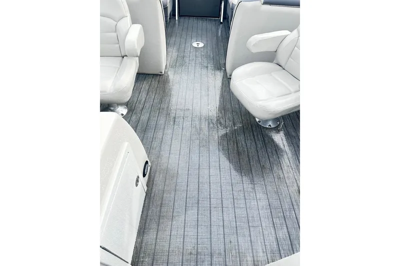 Slide: The Image of 2019 Starcraft 2210 OB Limited boat interior with wet flooring and white seating. - 15