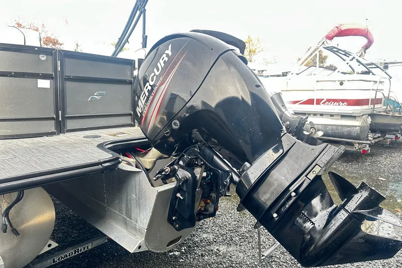 Slide: The Image of 2019 Starcraft 2210 OB Limited boat with Mercury outboard motor in a marina setting. - 16