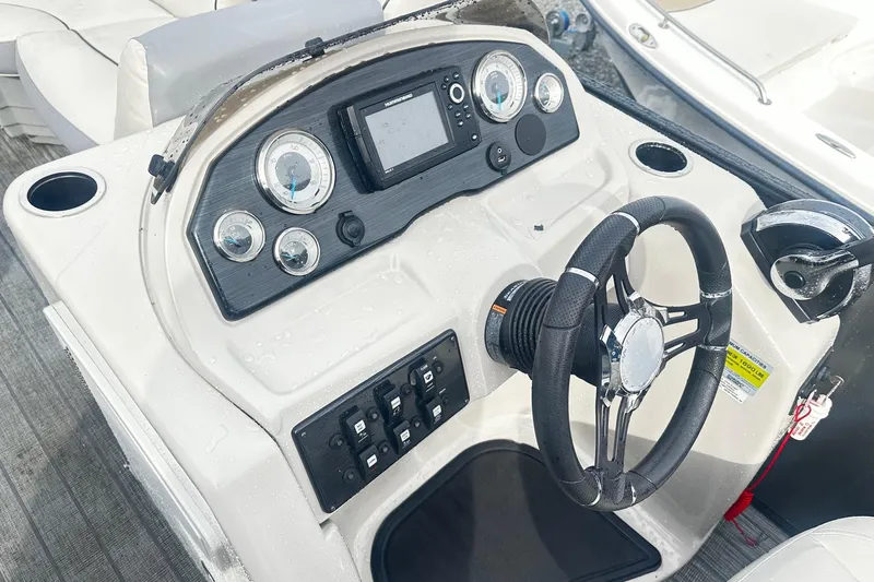 Slide: The Image of 2019 Starcraft 2210 OB Limited boat dashboard with steering wheel and control panel. - 4