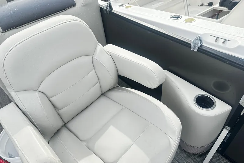 Slide: The Image of 2019 Starcraft 2210 OB Limited boat seat with cup holder, featuring white upholstery. - 8
