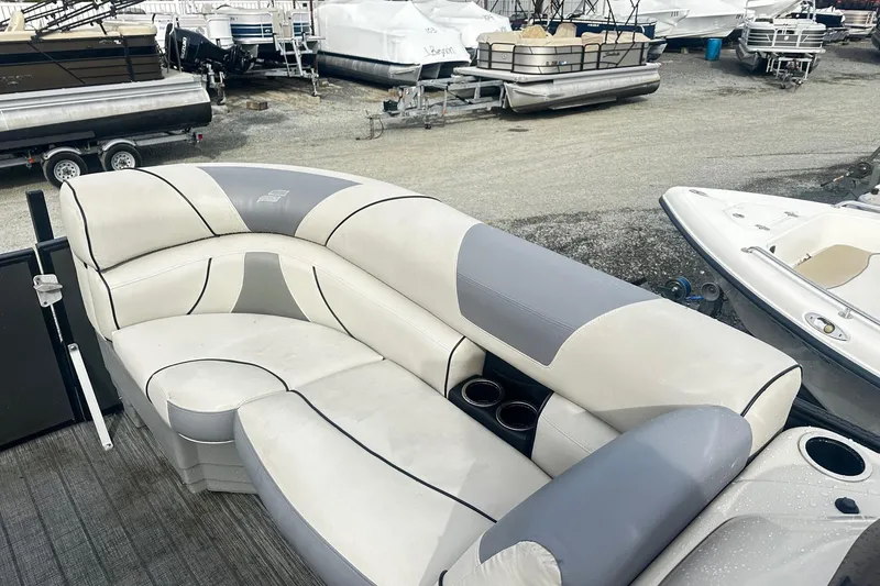 Slide: The Image of 2019 Starcraft 2210 OB Limited boat with gray and white seating in a marina. - 9