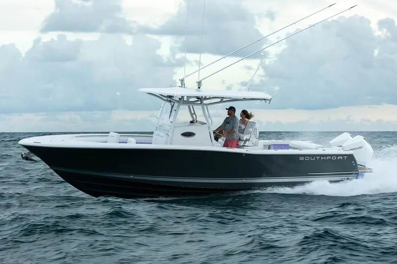 Slide: The Image of Manufacturer Provided Image: 2025 Southport 30 FE boat cruising on water near tropical shoreline. - 0