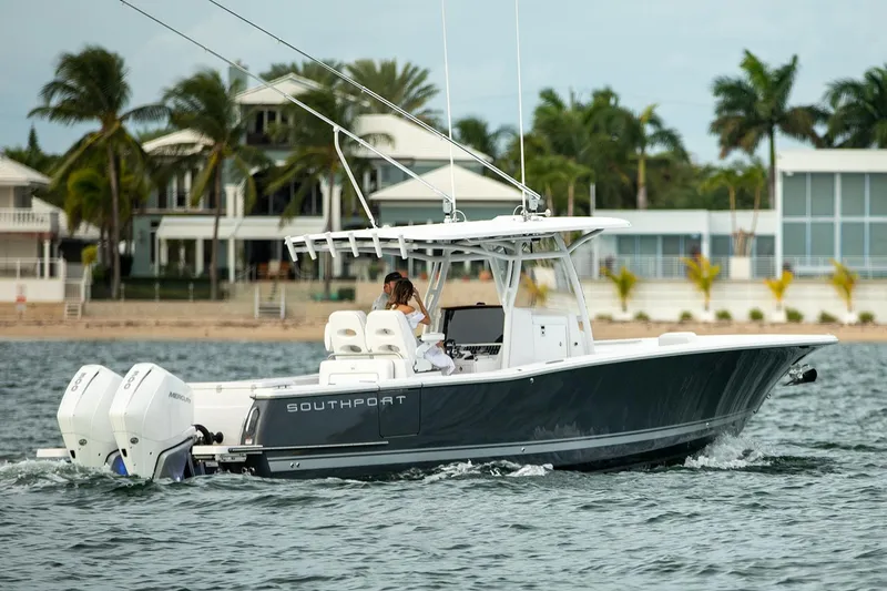 Slide: The Image of Manufacturer Provided Image: 2025 Southport 30 FE boat cruising on open water under cloudy skies. - 1