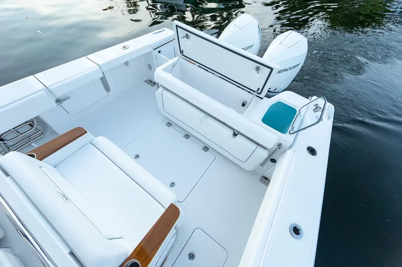 Slide: The Image of Manufacturer Provided Image: 2025 Southport 30 FE boat interior with seating and storage, featuring twin outboard engines. - 10