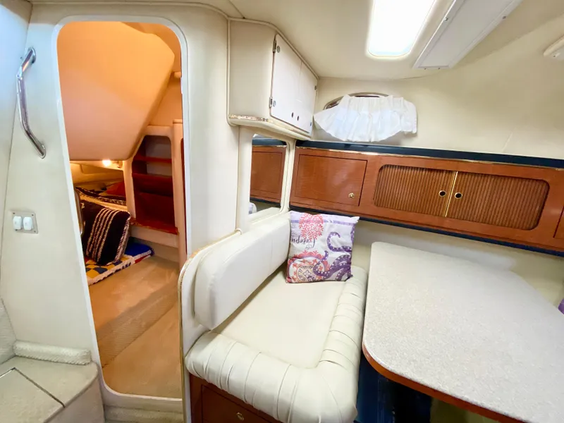 Slide: The Image of Interior of 2001 Sea Ray 290 Sundancer with cozy seating and cabin area. - 16