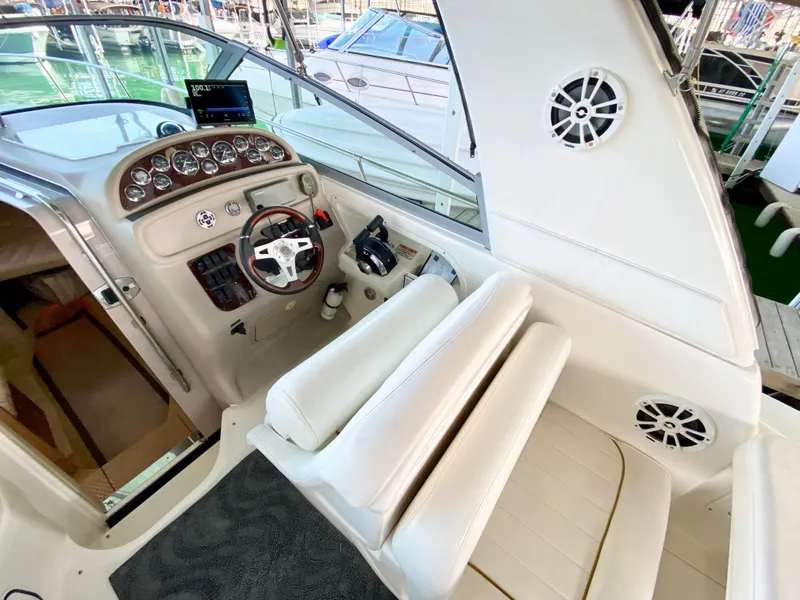 Slide: The Image of Interior of 2001 Sea Ray 290 Sundancer boat with steering wheel and seating. - 21