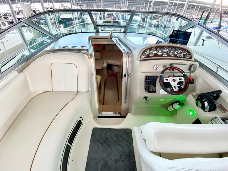 Slide: The Image of Interior of 2001 Sea Ray 290 Sundancer boat with helm and seating area. - 24