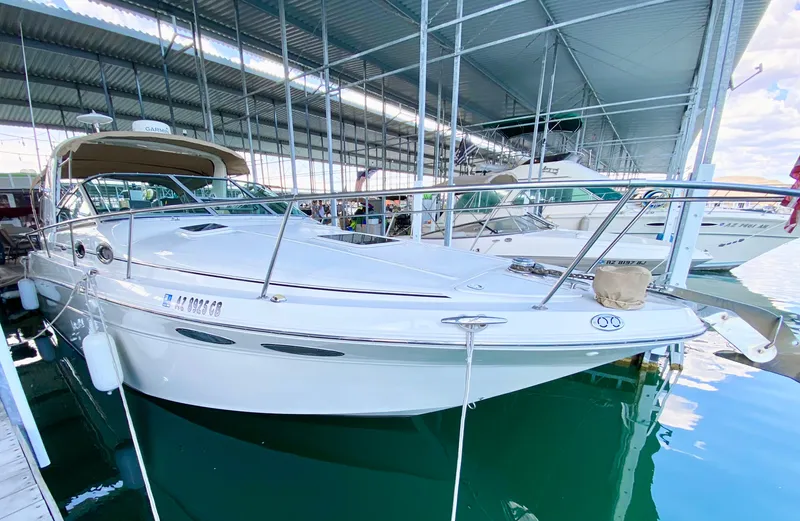 Slide: The Image of 2001 Sea Ray 290 Sundancer docked in a marina under a covered shelter. - 5