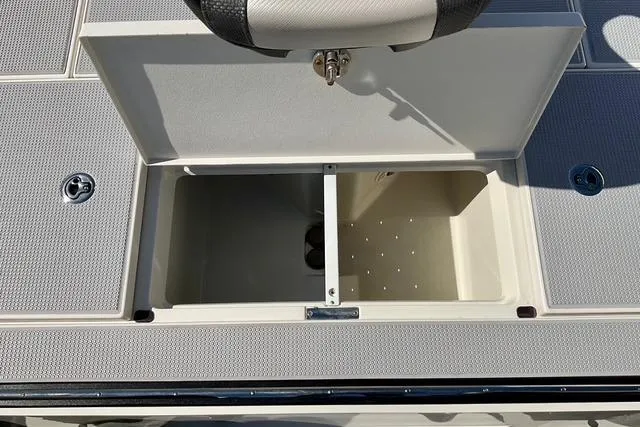 Slide: The Image of 2020 Ranger Z521L Intracoastal boat storage compartment with open lid, showcasing interior space. - 12