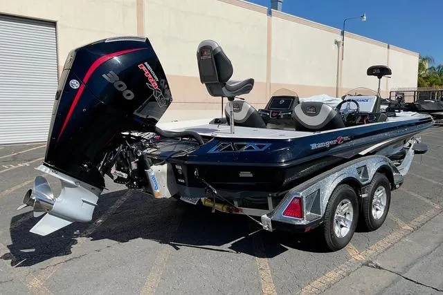Slide: The Image of 2020 Ranger Z521L Intracoastal boat with powerful outboard motor, parked on a trailer. - 2