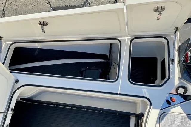 Slide: The Image of 2020 Ranger Z521L Intracoastal boat storage compartments open, showcasing interior space. - 22