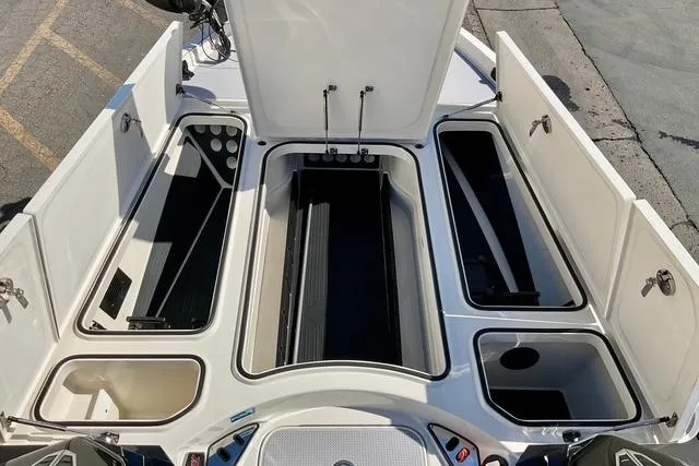 Slide: The Image of 2020 Ranger Z521L Intracoastal boat storage compartments open, showcasing spacious interior design. - 23