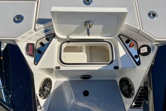 Slide: The Image of 2020 Ranger Z521L Intracoastal boat deck with open storage compartment and speakers. - 24
