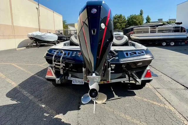 Slide: The Image of 2020 Ranger Z521L Intracoastal boat, rear view with outboard motor, parked outdoors. - 4