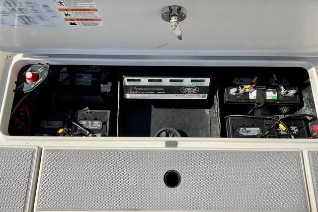 Slide: The Image of 2020 Ranger Z521L Intracoastal boat battery compartment with multiple batteries and wiring. - 9