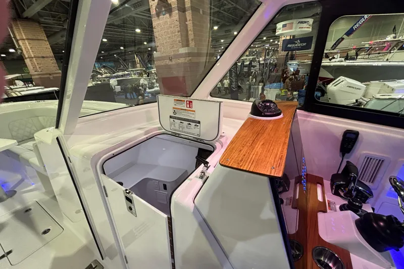 Slide: The Image of Interior view of 2026 Southport 33 DC boat cockpit at a boat show. - 16