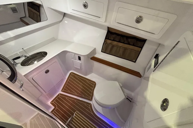 Slide: The Image of 2026 Southport 33 DC boat interior with seating and storage compartments. - 18