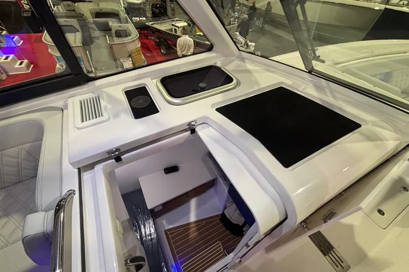Slide: The Image of Interior cabin of 2026 Southport 33 DC boat with sleek design and blue cushions. - 19