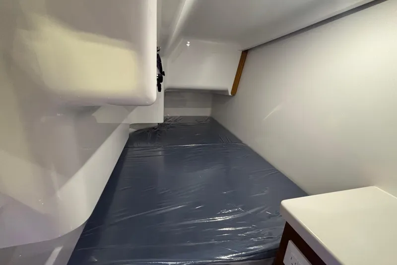 Slide: The Image of 2026 Southport 33 DC boat with Mercury engine displayed indoors. - 22