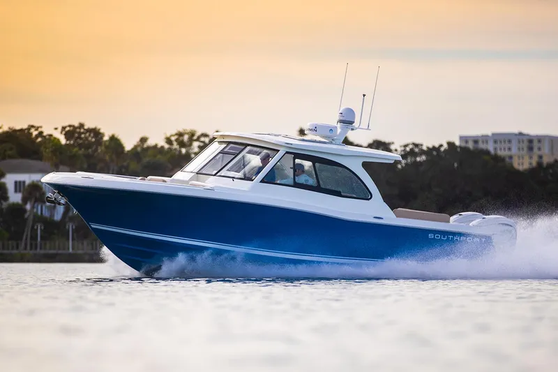 Slide: The Image of Manufacturer Provided Image: 2025 Southport 33 DC boat cruising on water at sunset. - 4