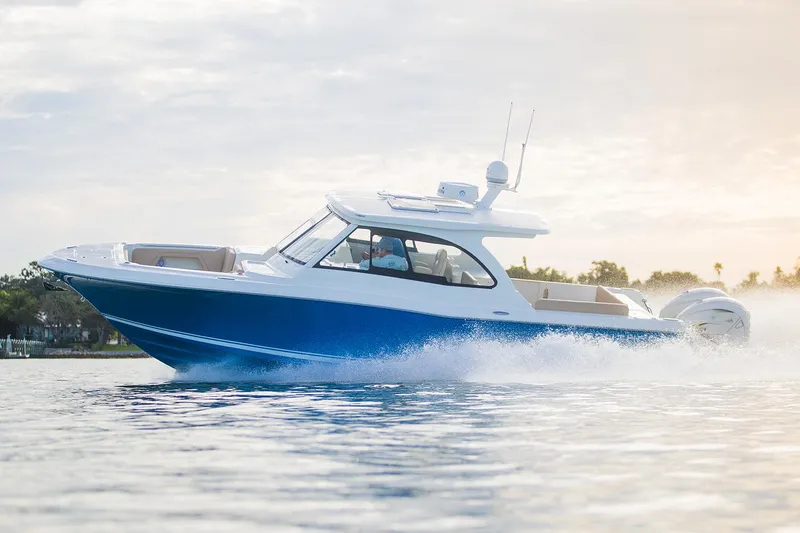 Slide: The Image of Manufacturer Provided Image: 2025 Southport 33 DC boat cruising on water, showcasing sleek design and performance. - 6