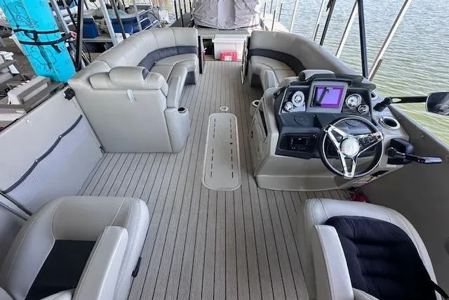 Slide: The Image of Interior of a 2021 Silver Wave 2410 SW7 JS pontoon boat with plush seating and modern dashboard. - 10