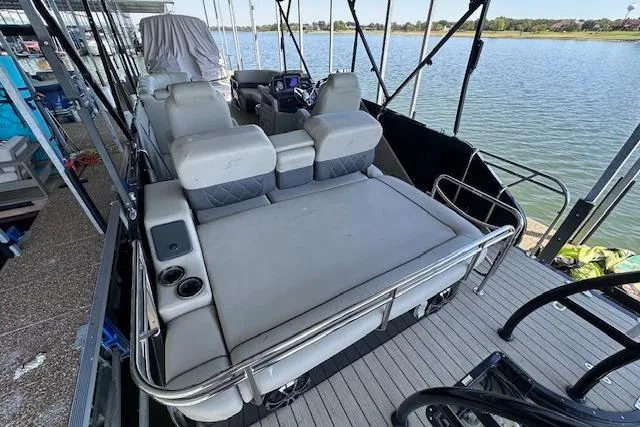 Slide: The Image of 2021 Silver Wave 2410 SW7 JS pontoon boat with spacious seating, docked by a serene lake. - 15