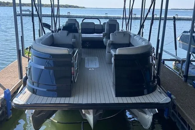 Slide: The Image of 2021 Silver Wave 2410 SW7 JS pontoon boat docked on a serene lake. - 2