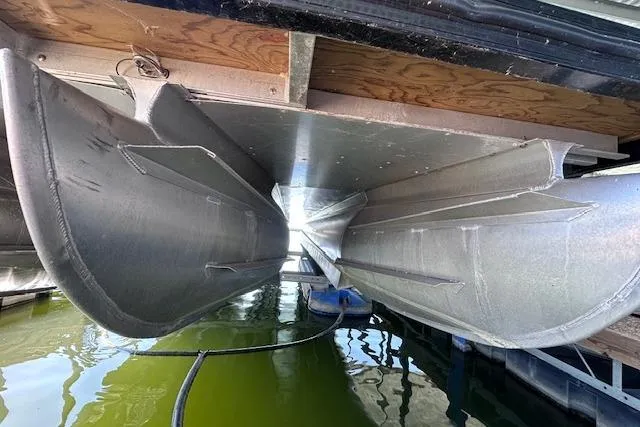 Slide: The Image of Underneath view of a 2021 Silver Wave 2410 SW7 JS pontoon boat in dock. - 4