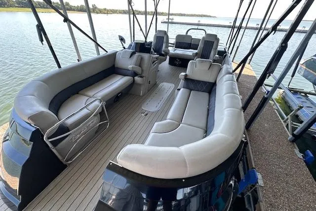 Slide: The Image of 2021 Silver Wave 2410 SW7 JS pontoon boat with spacious seating on a serene lake. - 5