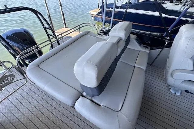 Slide: The Image of Luxury seating on 2021 Silver Wave 2410 SW7 JS pontoon boat, docked by the water. - 9