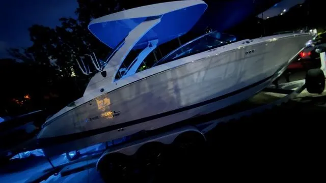 Slide: The Image of 2025 Regal LS9 Surf boat illuminated at night, showcasing sleek design and modern features. - 122