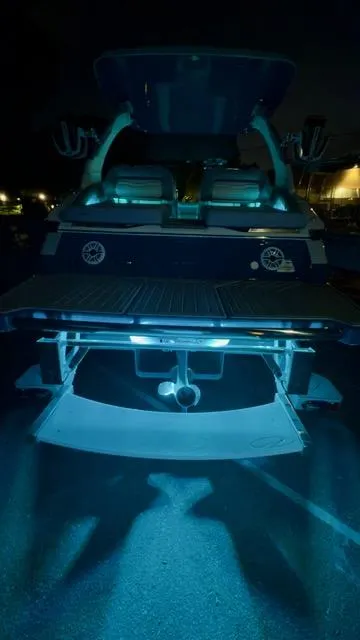 Slide: The Image of 2025 Regal LS9 Surf boat with illuminated deck at night. - 126