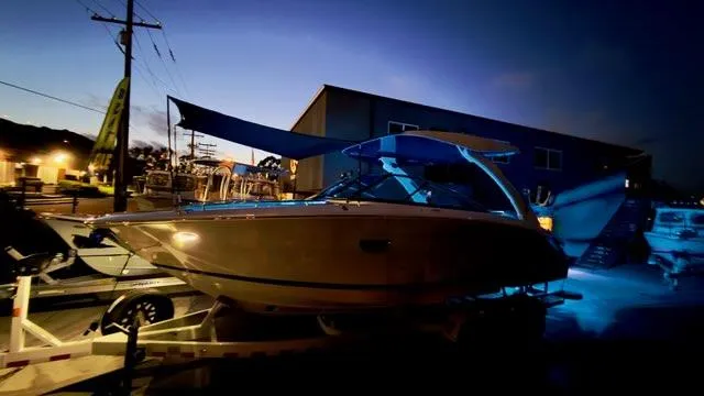 Slide: The Image of 2025 Regal LS9 Surf boat illuminated at night, showcasing sleek design and modern features. - 127