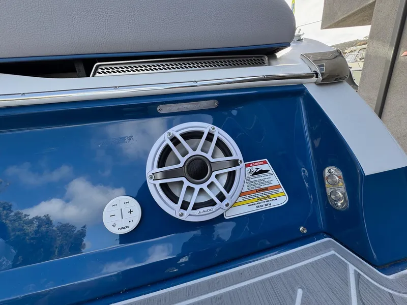Slide: The Image of 2025 Regal LS9 Surf boat speaker and control panel on blue exterior. - 37