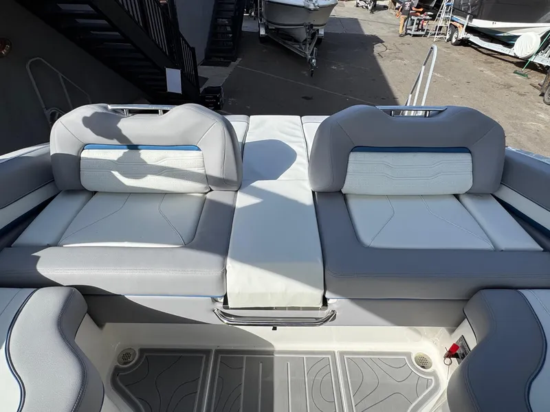 Slide: The Image of 2025 Regal LS9 Surf boat interior with gray and white seating. - 46