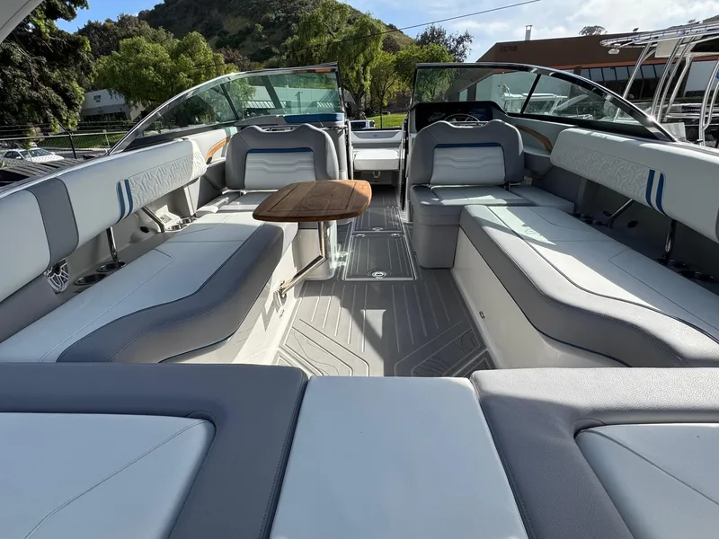 Slide: The Image of 2025 Regal LS9 Surf boat interior with luxurious seating and wooden table. - 47