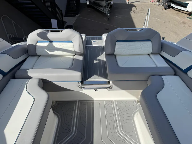 Slide: The Image of 2025 Regal LS9 Surf boat interior with gray and white seating, showcasing modern design. - 49