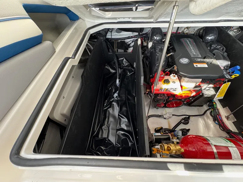Slide: The Image of Engine compartment of 2025 Regal LS9 Surf boat, featuring modern components and fire extinguisher. - 52