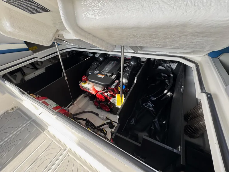 Slide: The Image of 2025 Regal LS9 Surf boat engine compartment with visible components and storage areas. - 54